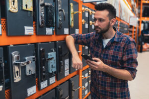 Customer browsing lock options at a shop offering full-service locksmith solutions