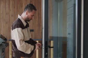 Technician configuring remote worker smart lock system installation